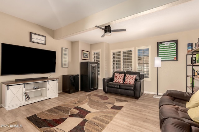 living room featuring ceiling fan and light hardwood / wood-style flooring