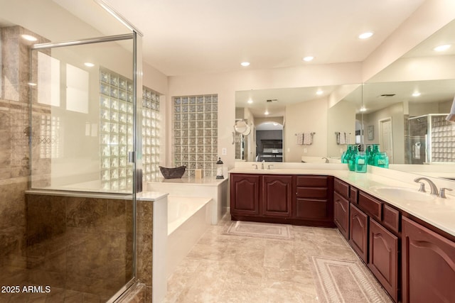 bathroom featuring independent shower and bath and vanity