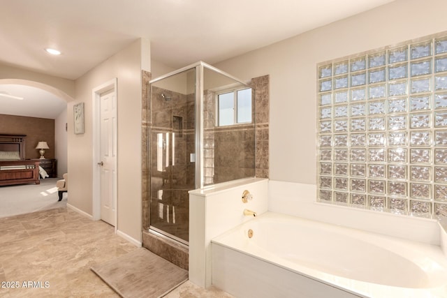 bathroom featuring shower with separate bathtub