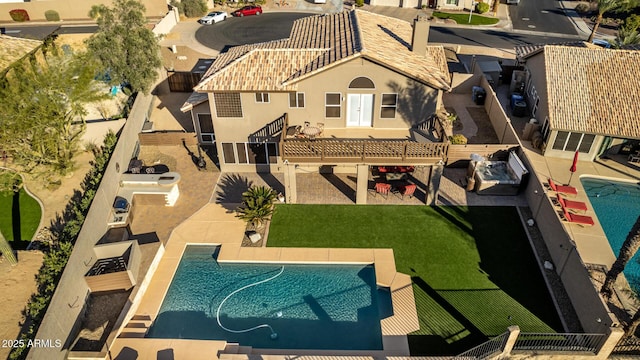 view of pool with a lawn and a patio