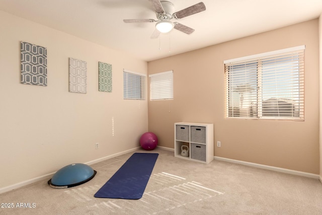 workout room featuring ceiling fan and light colored carpet