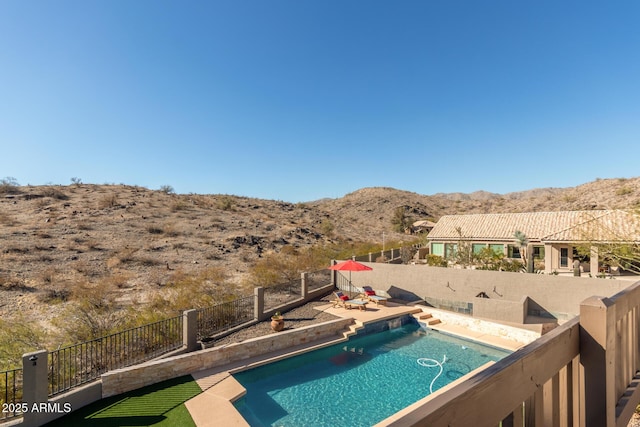 view of swimming pool featuring a mountain view