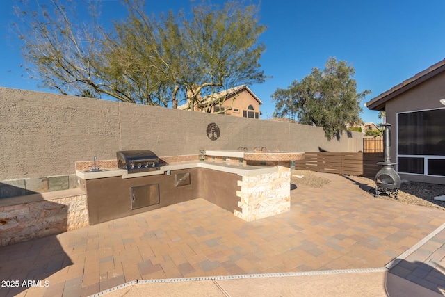 view of patio / terrace featuring an outdoor kitchen and grilling area