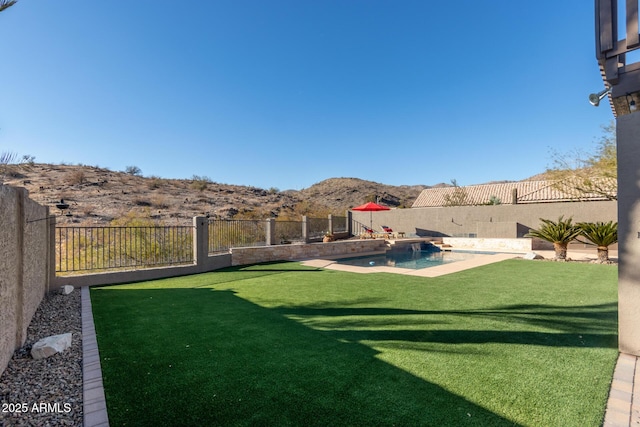 view of yard with a mountain view and a fenced in pool