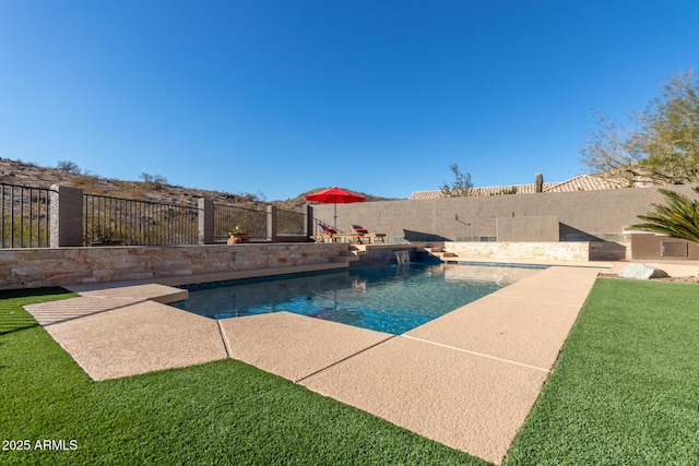 view of pool with a yard