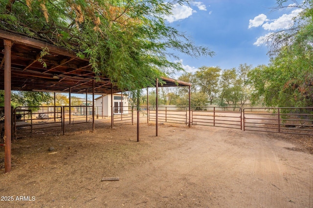 view of horse barn with a rural view