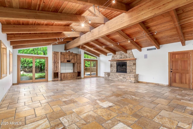 unfurnished living room featuring a fireplace, beam ceiling, high vaulted ceiling, and wooden ceiling