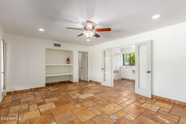 unfurnished bedroom with ceiling fan and french doors