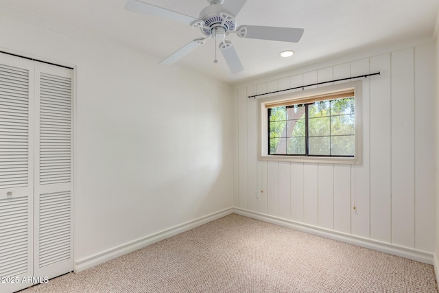 unfurnished bedroom with ceiling fan, a closet, and carpet floors