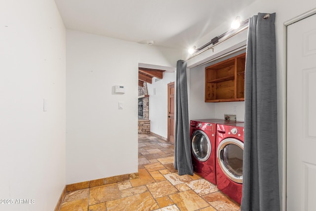 washroom with cabinets and washer and dryer