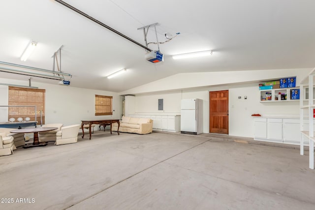 garage featuring electric panel, white fridge, and a garage door opener