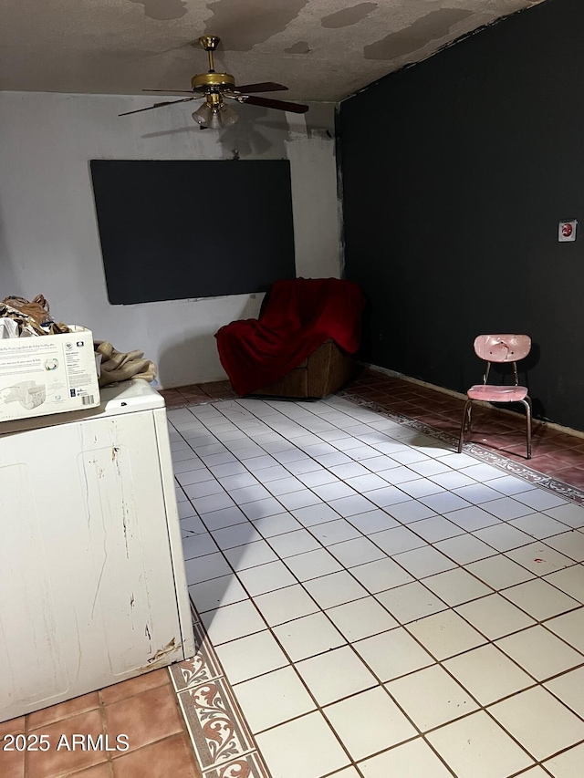 unfurnished living room featuring ceiling fan and light tile patterned floors