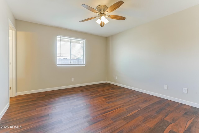 unfurnished room featuring dark wood-style floors, baseboards, and a ceiling fan