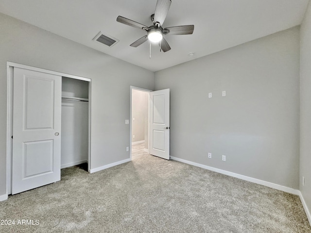 unfurnished bedroom with ceiling fan, a closet, and light colored carpet