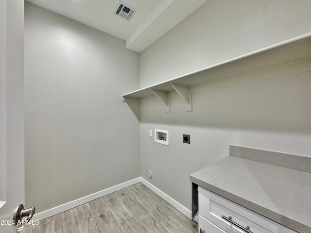 clothes washing area with hookup for an electric dryer, hookup for a washing machine, and light hardwood / wood-style flooring