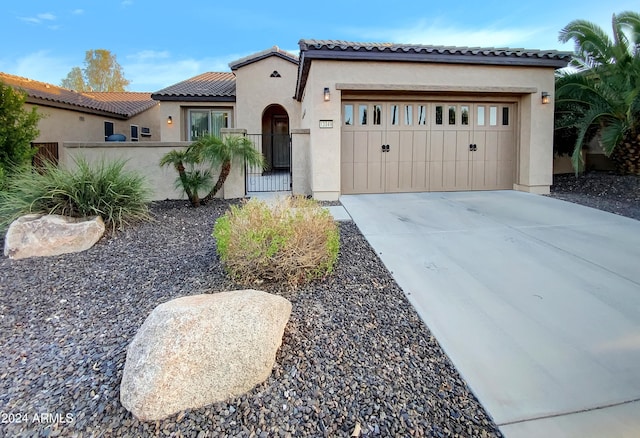 mediterranean / spanish-style house with a garage