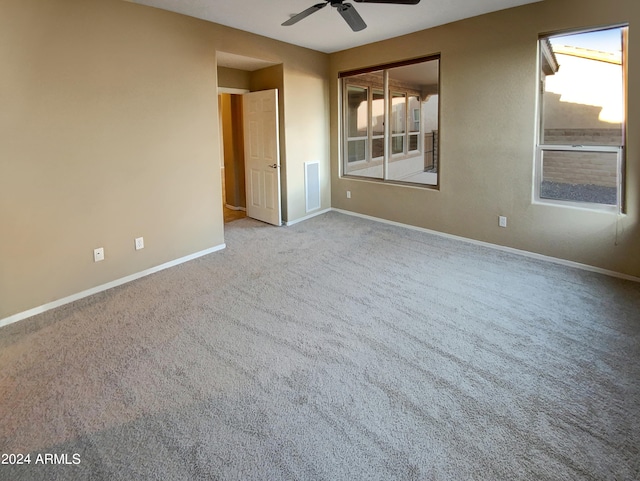 spare room with ceiling fan and carpet flooring