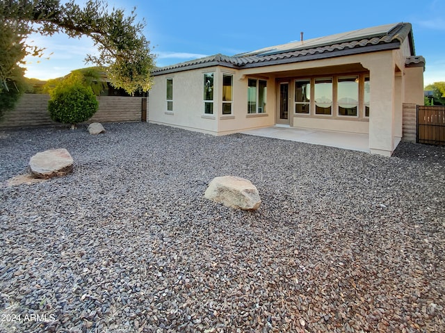 rear view of property featuring a patio