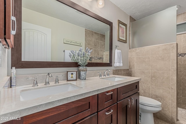 1121 W Mission Dr, Chandler, AZ 85224 - bathroom with toilet, double vanity, tile walls, and a textured ceiling