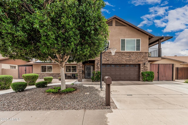 1121 W Mission Dr, Chandler, AZ 85224 - view of front of property featuring stone siding, stucco siding, an attached garage, concrete driveway, and a gate