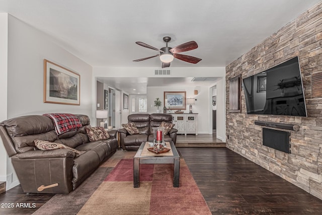 1121 W Mission Dr, Chandler, AZ 85224 - living room with ceiling fan, wood finished floors, a stone fireplace, and baseboards