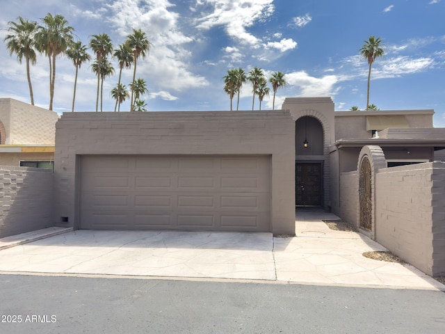 7770 E Camelback Rd Unit 23, Scottsdale, AZ 85251 - view of front of property featuring a garage, driveway, and stucco siding