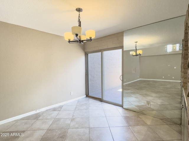 7770 E Camelback Rd Unit 23, Scottsdale, AZ 85251 - unfurnished dining area with a chandelier, light tile patterned floors, and baseboards