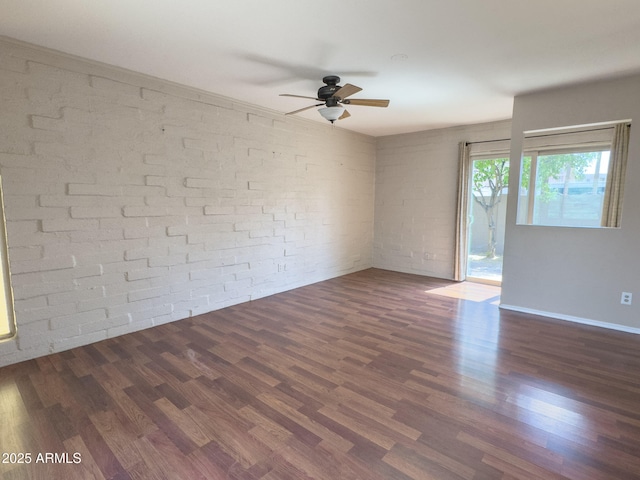 7770 E Camelback Rd Unit 23, Scottsdale, AZ 85251 - empty room with a ceiling fan, wood finished floors, and brick wall
