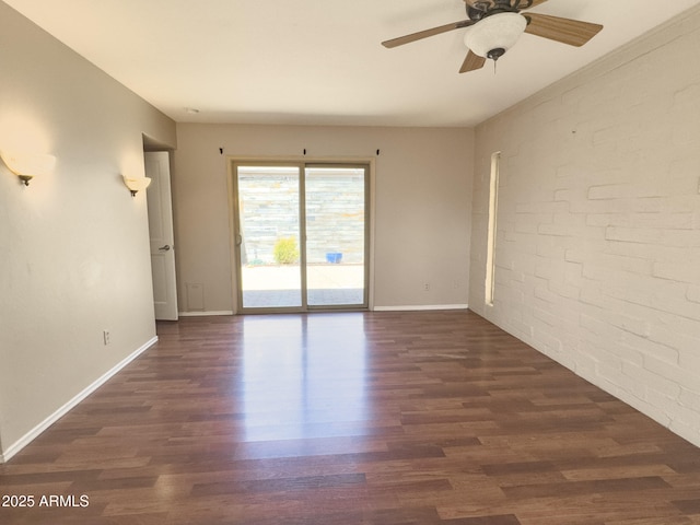 7770 E Camelback Rd Unit 23, Scottsdale, AZ 85251 - spare room featuring wood finished floors, a ceiling fan, brick wall, and baseboards