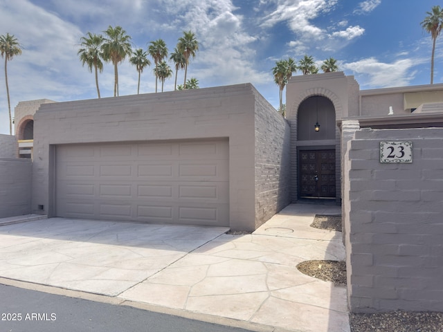 7770 E Camelback Rd Unit 23, Scottsdale, AZ 85251 - view of front facade with concrete driveway and stucco siding
