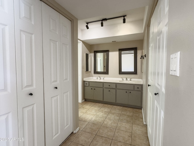7770 E Camelback Rd Unit 23, Scottsdale, AZ 85251 - bathroom featuring a closet, double vanity, track lighting, and tile patterned flooring