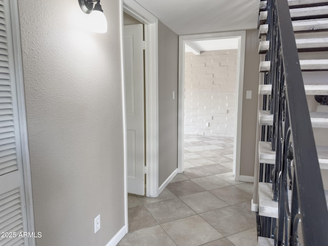 7770 E Camelback Rd Unit 23, Scottsdale, AZ 85251 - hallway with light tile patterned flooring and baseboards