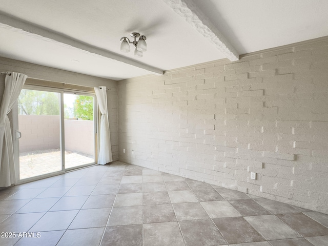 7770 E Camelback Rd Unit 23, Scottsdale, AZ 85251 - tiled spare room with brick wall and beamed ceiling