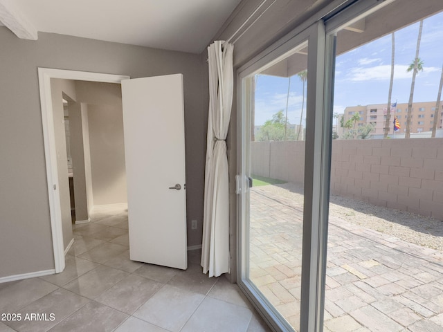 7770 E Camelback Rd Unit 23, Scottsdale, AZ 85251 - doorway to outside with healthy amount of natural light and light tile patterned floors