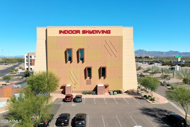 7770 E Camelback Rd Unit 23, Scottsdale, AZ 85251 - view of building exterior featuring uncovered parking and a mountain view