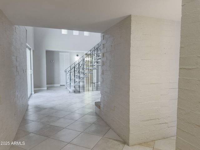 7770 E Camelback Rd Unit 23, Scottsdale, AZ 85251 - hall featuring stairway and light tile patterned floors