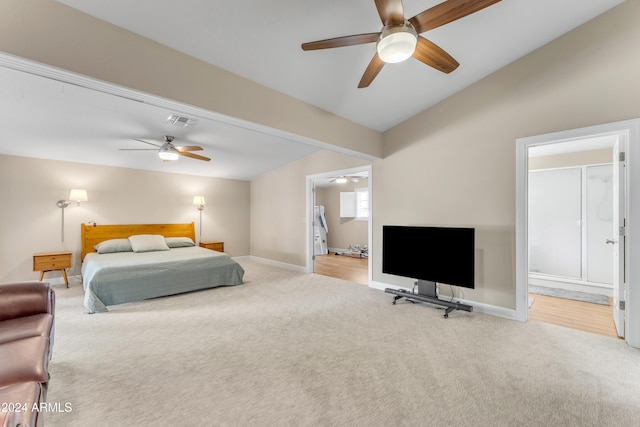 bedroom featuring carpet, ensuite bathroom, ceiling fan, and lofted ceiling