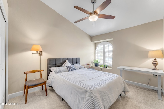 bedroom featuring light carpet, a closet, vaulted ceiling, and ceiling fan