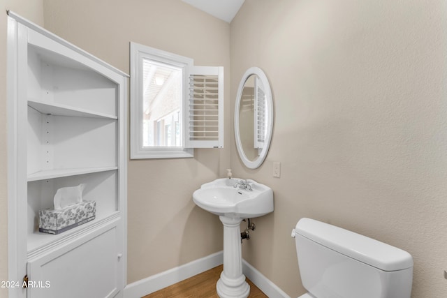 bathroom with hardwood / wood-style floors and toilet