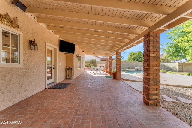 view of patio with a fenced in pool