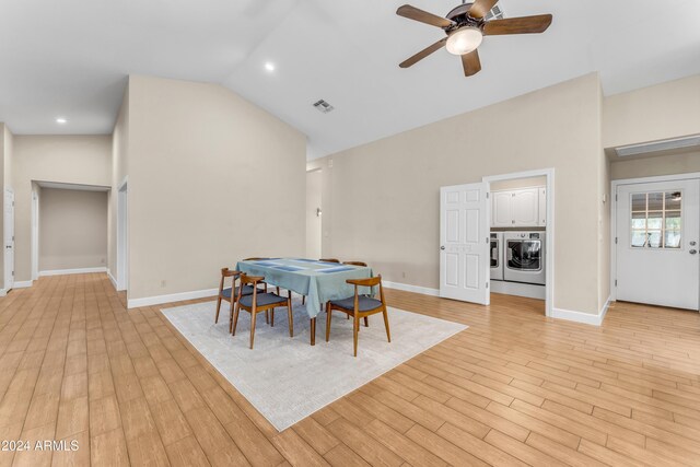 dining space featuring washer and dryer, light hardwood / wood-style floors, ceiling fan, and lofted ceiling