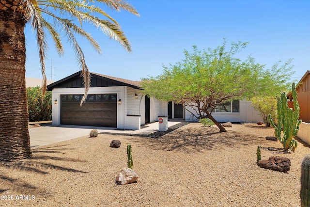 811 E Brown St, Phoenix, AZ 85020 - view of front of property with concrete driveway, an attached garage, and board and batten siding