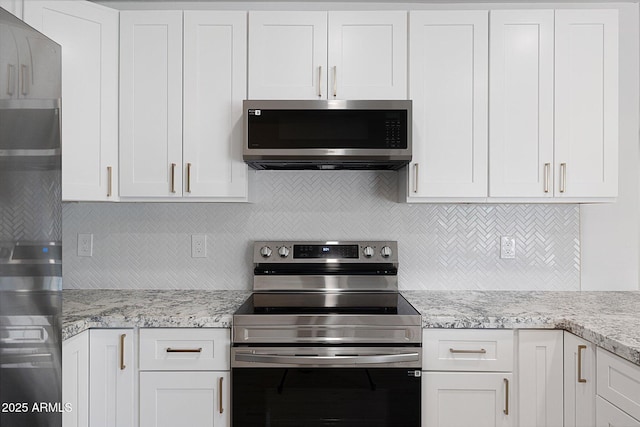 811 E Brown St, Phoenix, AZ 85020 - kitchen with stainless steel appliances, tasteful backsplash, white cabinetry, and light stone countertops