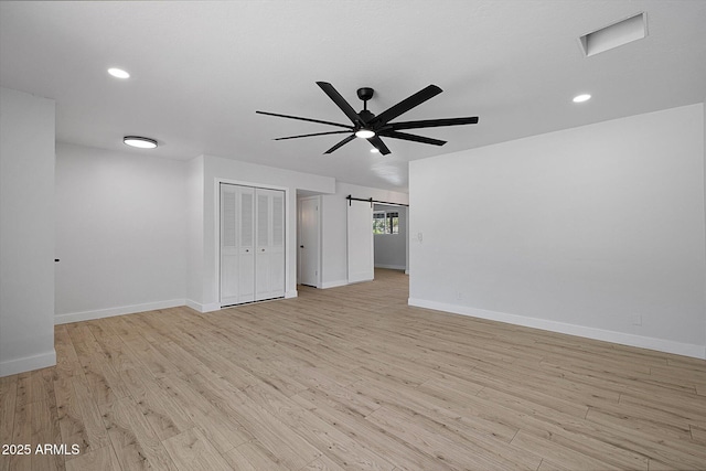811 E Brown St, Phoenix, AZ 85020 - spare room featuring ceiling fan, light wood-style flooring, a barn door, and recessed lighting