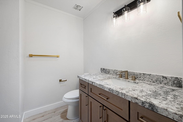 811 E Brown St, Phoenix, AZ 85020 - half bathroom featuring vanity, ornamental molding, and wood finished floors