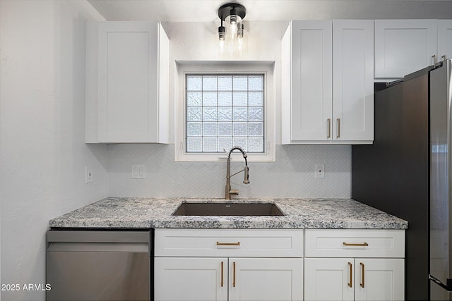 811 E Brown St, Phoenix, AZ 85020 - kitchen with stainless steel appliances, decorative backsplash, light stone countertops, and white cabinets