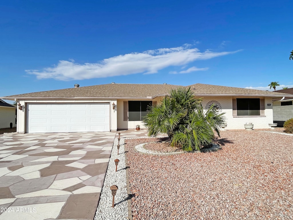 ranch-style home featuring a garage