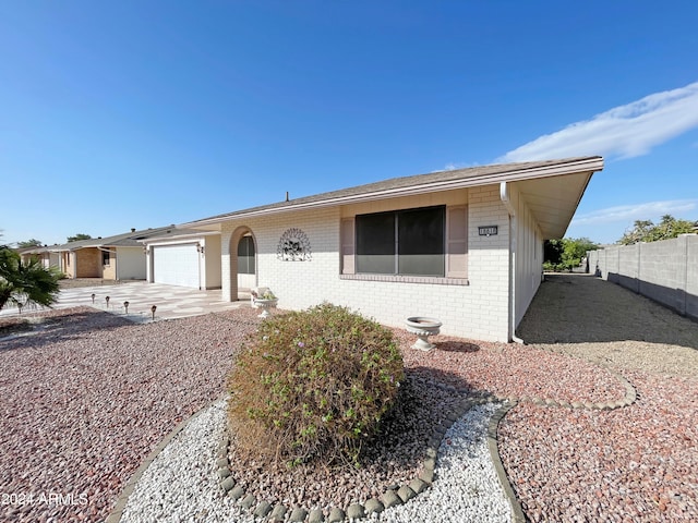 ranch-style home featuring a garage