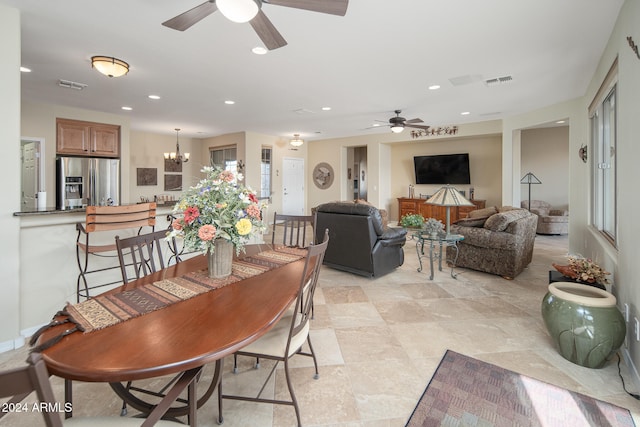 dining room with ceiling fan with notable chandelier