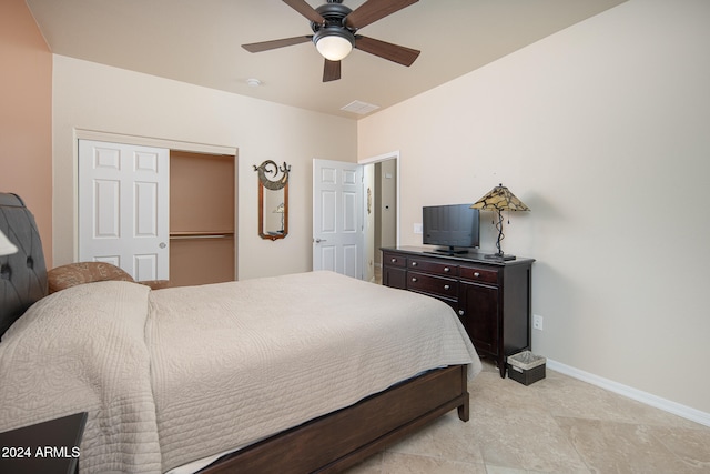 bedroom featuring light tile patterned floors, a closet, and ceiling fan